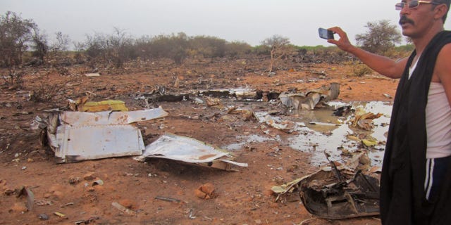 July 25, 2014 - French soldiers secured a black box from the Air Algerie wreckage site in a desolate region of restive northern Mali. The French president said terrorism hasn't been ruled out as a cause, although officials say the most likely reason for the catastrophe that killed all onboard is bad weather. At least 118 people were killed in the disaster, nearly half of whom were French. (Burkina Faso military)