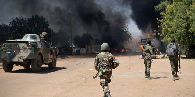 Feb. 21, 2013: Malian soldiers, working with French forces, battling radical Islamic rebels in Gao, Mali.