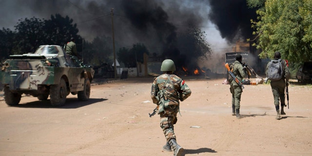Feb. 21, 2013: Malian soldiers, working with French forces, battling radical Islamic rebels in Gao, Mali.