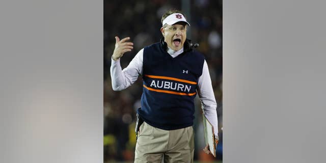 FILE - In this Jan. 6, 2014, file photo, Auburn head coach Gus Malzahn yells during the first half of the NCAA BCS National Championship college football game against Florida State in Pasadena, Calif. Malzahn has a long way to go to challenge Alabama coach Nick Saban's résumé that includes three national titles at Alabama and one at LSU. His Tigers open against his home state team, Arkansas, on Saturday Aug. 30, 2014.(AP Photo/David J. Phillip, File)