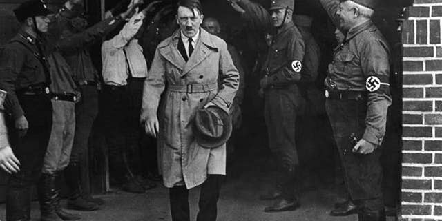 Adolf Hitler, leader of the National Socialists, emerges from the party's Munich headquarters.