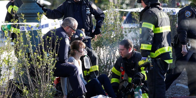 A woman is aided by first responders after sustaining injury on a bike path in lower Manhattan in New York, NY, U.S., October 31, 2017. REUTERS/Brendan McDermid - RC14C171D340