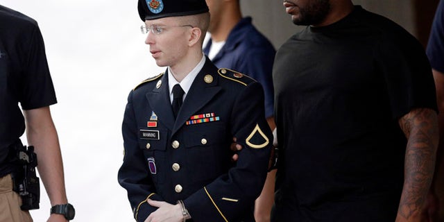July 15, 2013: Army Pfc. Bradley Manning, center, is escorted to a waiting security vehicle outside of a courthouse in Fort Meade, Md., after appearing for a hearing at his court martial.