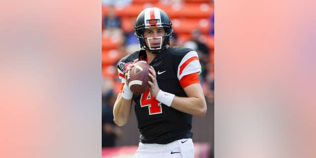 FILE - In a Dec. 24, 2013, file photo Oregon State quarterback Sean Mannion looks for an open receiver in the second quarter of the Hawaii Bowl NCAA college football game against Boise State, in Honolulu. The once the soft-spoken and reserved quarterback for the Oregon State has blossomed into a confident full-fledged leader in his senior season for the Beavers. (AP Photo/Eugene Tanner, file)