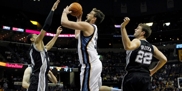 Memphis Grizzlies center Marc Gasol, of Spain, (33) shoots under pressure by San Antonio Spurs forward Danny Green (4) in the second half of an NBA basketball game on Monday, Feb. 6, 2012, in Memphis, Tenn. (AP Photo/Jim Weber)