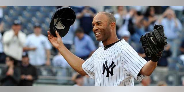 New York Yankees closer Mariano Rivera acknowledges the cheers of the crowd after recording his 602nd career save, after the Yankees beat the Minnesota Twins 6-4 in a baseball game, Monday, Sept. 19, 2011, at Yankee Stadium in New York. Rivera pitched a perfect ninth as he broke the record held by Trevor Hoffman. (AP Photo/Kathy Kmonicek)
