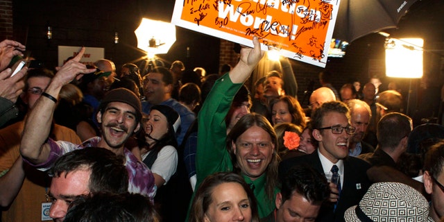 Nov. 6, 2012: People attending an Amendment 64 watch party in a bar celebrate after a local television station announced the marijuana amendment's passage, in Denver, Colo.