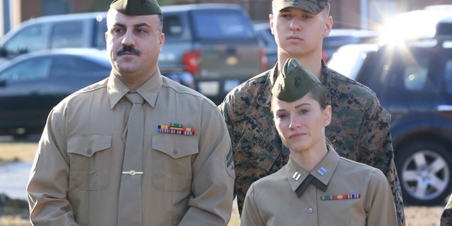 Feb. 9, 2015: Cpl. Wassef Hassoun, left, is escorted to the courtroom on Camp Lejeune in Jacksonville, N.C., for the beginning of his court martial trial. (AP/The Daily News, John Althouse)