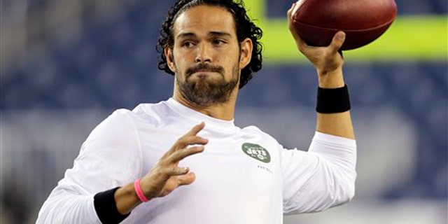FILE - In a Sept. 12, 2013 filel photo, New York Jets quarterback Mark Sanchez, who normally throws right-handed, throws a pass with his left hang before an NFL football between the New England Patriots and the Jets game, in Foxborough. The New York Jets released Sanchez signed quarterback Michael Vick on Friday, March 21, 2014. Sanchez spent this past season on injured reserve after injuring his right shoulder in a preseason game. (AP Photo/Charles Krupa, File)
