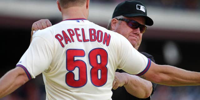 Philadelphia Phillies pitcher Jonathan Papelbon argues with Umpire Joe West after being ejected from the game against the Miami Marlins in the ninth inning of a baseball game Sunday, Sept. 14, 2014, in Philadelphia. The Marlins won 5-4. (AP Photo/H. Rumph Jr)