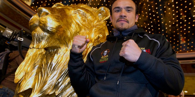 Juan Manuel Marquez poses for photographers upon arriving at the MGM Grand Hotel and Casino, Monday, Nov. 7, 2011, in Las Vegas. Juan Manuel Marquez will face Manny Pacquiao for the world welterweight championship on Saturday. (AP Photo/Julie Jacobson)