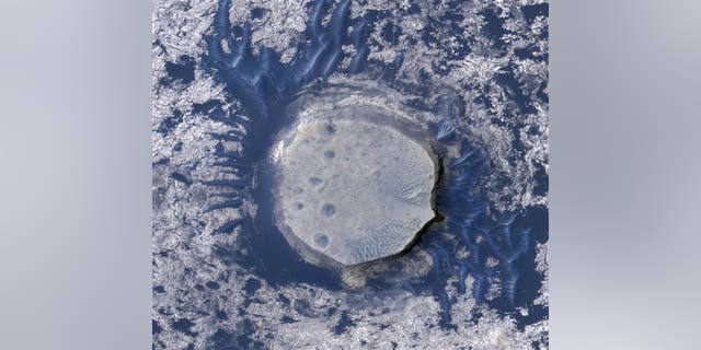 An inverted crater in the Arabia Terra region of Mars is among the images taken by NASA's Mars Reconnaissance Orbiter in early 2010. Scientists are impressed with the flood of data beamed back by the craft; the space agency said the Orbiter has sent back 100 terabits of data: equal to about 3 million MP3s.