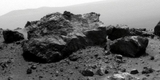 Aug. 13, 2011: NASA's Mars Exploration Rover Opportunity looked across a small crater on the rim of a much larger crater to capture this raw image from its panoramic camera during the rover's 2,685th Martian day, or sol, of work on Mars.