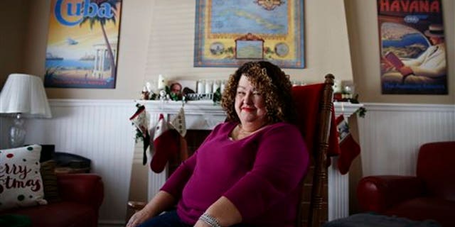 Cuban food blogger Marta Darby poses for photos in her home on Tuesday, Dec. 17, 2013, in Mission Viejo, Calif. Darby will be making a toast to Cuba this year, accompanied with a glass of the rum-based eggnog known as the "creme de vie" or "cream of life." (AP Photo/Jae C. Hong)