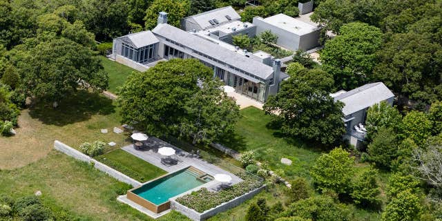 On the grounds, there's an infinity-edge swimming pool, a two-bedroom guesthouse, an outdoor kitchen and a basketball court.