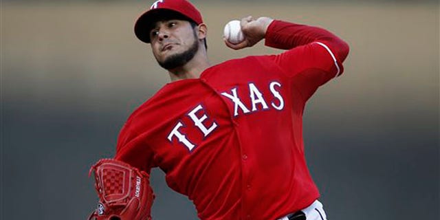Texas Rangers starting pitcher Martin Perez throws to the Boston Red Sox during the first inning of a baseball game on Saturday, May 10, 2014, in Arlington, Texas. (AP Photo/Jim Cowsert)