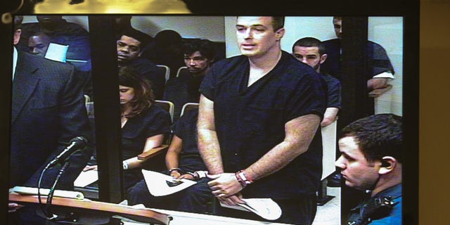 Matthew Apperson makes a first appearance in Seminole County court at the John E Polk correctional facility, seen on a video monitor, in Sanford, Fla. on Saturday May 16, 2015. Apperson was charged Friday with aggravated assault with a deadly weapon, aggravated battery with a deadly weapon and firing a deadly missile into an occupied conveyance stemming from an incident involving George Zimmerman earlier in the week. (Joshua C. Cruey/Orlando Sentinel via AP) MAGS OUT; NO SALES
