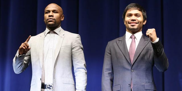 LOS ANGELES, CA - MARCH 11: Floyd Mayweather (L) and Manny Pacquiao pose together at the start of their Press Conference promoting their upcoming fight on March 11, 2015 in Los Angeles, California. (Photo by Stephen Dunn/Getty Images)