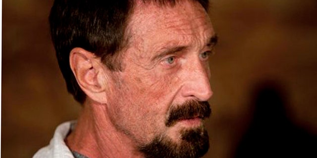 Software company founder John McAfee listens to a question during an interview at a local restaurant in Guatemala City, Tuesday, Dec. 4, 2012. McAfee, 67, has been identified as a "person of interest" in the killing of his neighbor in Belize, 52-year-old Gregory Faull. Police are urging McAfee to come in for questioning. The anti-virus company founder fled Belize and is seeking political asylum in Guatemala, according to his lawyer Telesforo Guerra. (AP Photo/Moises Castillo)