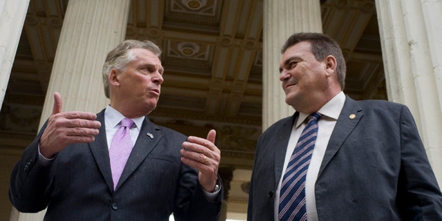 Virginia Governor Terry McAuliffe, left, talks with the dean of the University of Havana, Gustavo Suárez Cobreiro, in Havana, Cuba, Monday, Jan. 4, 2016. McAuliffe is in Havana heading a delegation that seeks to strengthen trade ties between the U.S. and Cuba, just over a year after the thawing of relations between the two countries. (AP Photo/Ramón Espinosa)