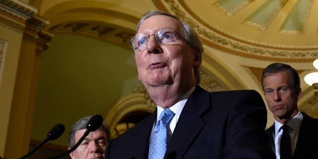 Senate Majority Leader Mitch McConnell of Ky., second from left, speaks to reporters following the weekly Republican luncheon on Capitol Hill in Washington, Tuesday, June 16, 2015. (AP Photo/Susan Walsh)