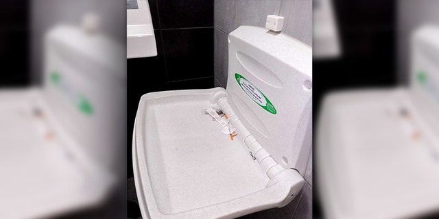 An English woman says she found three used needles on a baby changing table while dining out with her family and friends.