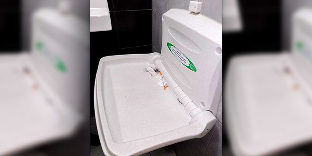 An English woman says she found three used needles on a baby changing table while dining out with her family and friends.