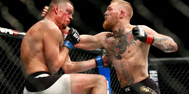 FILE - In this Saturday, March 5, 2016 file photo, Conor McGregor, right, trades punches with Nate Diaz during their UFC 196 welterweight mixed martial arts match in Las Vegas. Conor McGregor has packed a punch on social media rather than inside a UFC cage. One of the UFCs top draws, McGregor created a stir Tuesday, April 19, 2016 when he tweeted that retirement was on the horizon. (AP Photo/Eric Jamison, File)