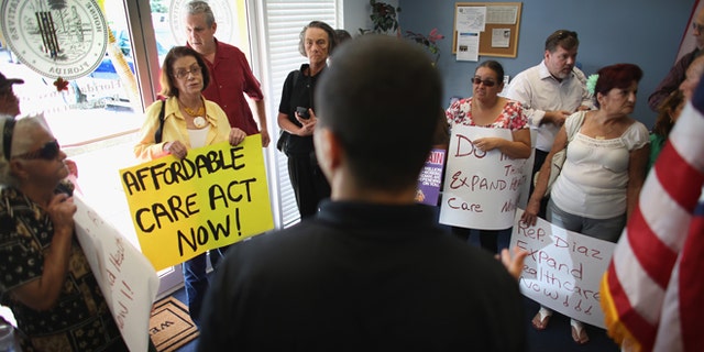 Daniel Martinez, an aide to Florida State Rep. Manny Diaz, speaks to protesters on September 20, 2013 in Miami, Florida.