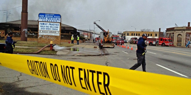 April 9, 2013: Caution tape lines the scene as a fire burns at Park Medical Centers building in Detroit. Two people remain unaccounted for in the gutted medical office building after a possible shooting and intentionally set fire, police said.