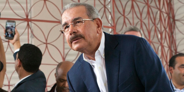 Danilo Medina casts his ballot during the general elections in Santo Domingo, Sunday, May 15, 2016.