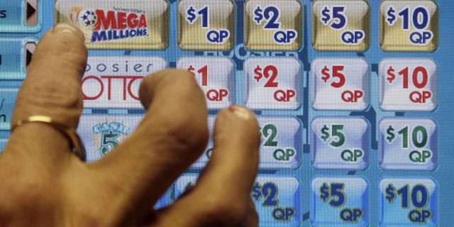 December 17, 2013: A clerk prepares to operate a lottery machine to print out Mega Millions lottery tickets for a customer in Muncie, Ind. The March 18, 2014 estimated $400 million Mega Millions jackpot could potentially be the sixth-largest in lottery prize in U.S. history. (AP Photo/Darron Cummings, File)