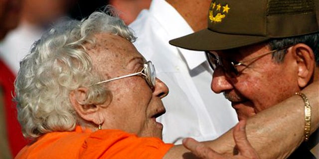In this July 26, 2010 file photo, Melba Hernandez, left, greets Cuba's President Raul Castro at a Revolution Day rally in Santa Clara, Cuba. Hernandez, who died on Sunday, March 9, 2014, helped found the Communist Party of Cuba and served as ambassador in Vietnam and Cambodia. She was 92.