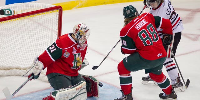 Halifax Mooseheads goaltender Zachary Fucale turns away a shot with the help of defenseman Austyn Hardie as Portland Winterhawks center Brendan Leipsic presses sduring the first period of a junior hockey Memorial Cup game Saturday, May 18, 2013, in Saskatoon, Saskatchewan. (AP Photo/The Canadian Press, Liam Richards)