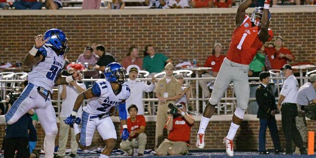 Mississippi wide receiver Laquon Treadwell (1) catches a touchdown pass as Memphis defensive backs Reggis Ball (39) and Bobby McCain (21) watch during the second half of an NCAA college football game in Oxford, Miss., Saturday, Sept. 27, 2014. No. 10 Mississippi won 24-3. (AP Photo/The Daily Mississippian, Thomas Graning)