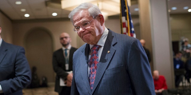 Sen. Bob Menendez, D-N.J., leaves after news conference in Newark, N.J. on Friday, March 6, 2015. A person familiar with a federal investigation says the Justice Department is expected to bring criminal charges against the New Jersey Democrat in the coming weeks. Menendez says that he has always behaved appropriately in office. (AP Photo/John Minchillo)