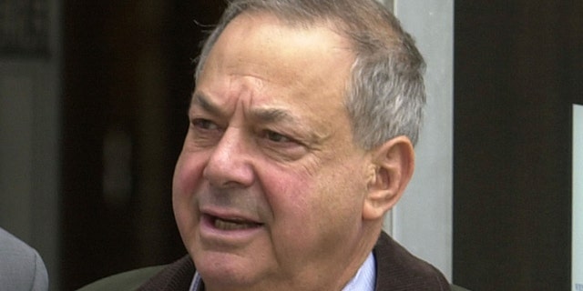 FILE - In this Oct. 15, 2003, file photo, Joseph Barry, president of Applied Development Co., of Hoboken, N.J., leaves the U.S. District Courthouse in Newark, N.J. Sen. Bob Menendez's legal defense fund raised nearly $1.3 million up until the day before he was indicted on bribery and corruption charges, including $10,000 from the retired Barry who served two years in prison for bribery. (AP Photo/Mike Derer, File)