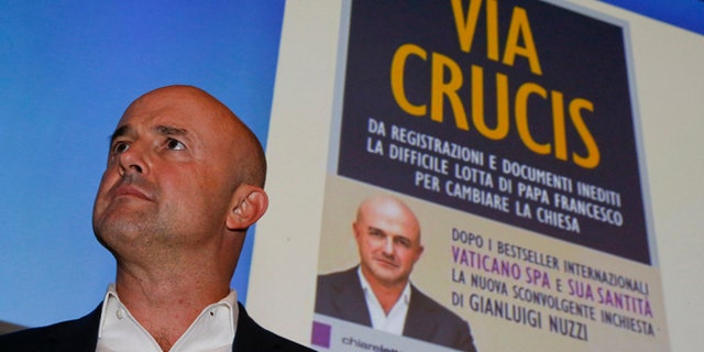 Italian journalist and writer Gianluigi Nuzzi attends a press conference to promote the release of his new book ''Via Crucis'' ("Merchants in the Temple", in the English language edition) in Milan, Italy, Monday, Nov. 16 2015. In his book Nuzzi makes some startling allegations, including a report that Vatican "postulators" - officials who promote sainthood causes - bring in hundreds of thousands of euros in donations for their causes but are subject to no oversight as to how the money is spent. (AP Photo/Luca Bruno)