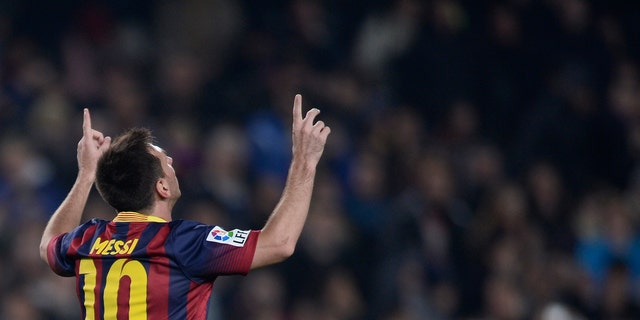 FC Barcelona's Lionel Messi, from Argentina, reacts after scoring against Getafe during a Copa del Rey soccer match at the Camp Nou stadium in Barcelona, Spain, Wednesday, Jan. 8, 2014. (AP Photo/Manu Fernandez)