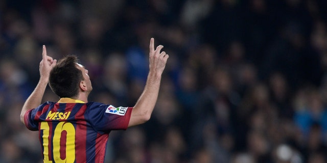 FC Barcelona's Lionel Messi, from Argentina, reacts after scoring against Getafe during a Copa del Rey soccer match at the Camp Nou stadium in Barcelona, Spain, Wednesday, Jan. 8, 2014. (AP Photo/Manu Fernandez)