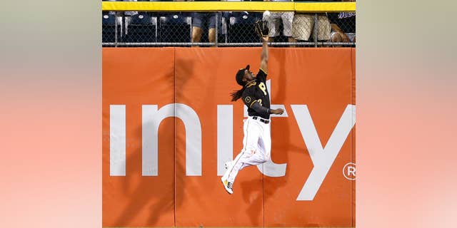 Pittsburgh Pirates center fielder Andrew McCutchen (22) leaps next to the wall to catch a deep fly ball by New York Mets' Curtis Granderson in the eighth inning of a baseball game Friday, June 27, 2014, in Pittsburgh. The Pirates won -3-2 in 11 innings. (AP Photo/Keith Srakocic)