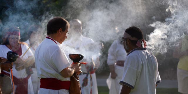 In this July 22, 2012 photo provided by the University of New Mexico, participants of a University of New Mexico workshop on curanderismo, or traditional Mexican folk healing, burn copal during a ceremony on campus. The Maxwell Museum of Anthropology in Albuquerque, N.M. is scheduled to host an exhibit this summer on curanderismo and will invite healers from Latin America to give talks on a traditional healing field that is growing in the United States thanks to immigration from Latin America. (AP Photo/Courtesy of the University of New Mexico)