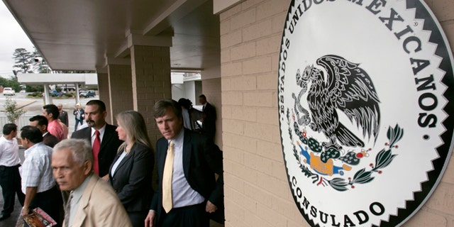 FILE - Visitors walk from the Mexican Consulate in Little Rock, Ark., after the grand opening of the building in this Wednesday, April 25, 2007 file photot. The Mexican government on Thursday Jan. 15, 2015 will start issuing birth certificates to its citizens at consulates in the United States, seeking to make it easier for them to apply for U.S. work permits, driver's licenses and protection from deportation. (AP Photo/Danny Johnston, File)