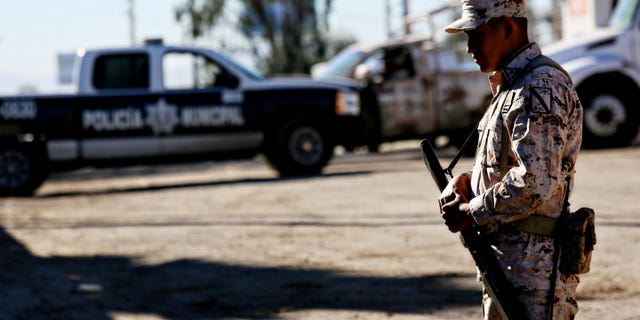 TIJUANA, MEXICO - OCTOBER 31: Mexican security officials stand guard outside of a factory where a drug tunnel was discovered leading into the United States on October 31, 2013 in Tijuana, Mexico. The tunnel was discovered last night just south of the Otay Mesa border crossing in a business park area. (Photo by Sandy Huffaker/Getty Images)