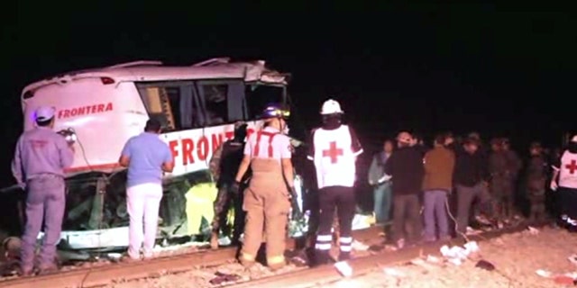 In this image made from Associated Press Television News video emergency responders work at the scene of a bus and freight train collision Friday Feb. 13, 2015. The collision at a grade crossing in northern Mexico, killed at least 16 people and injured 22, according to a Mexican official. The official said the accident Friday occured in the town of Anahuac, which is Tamaulipas state near the border city of Nuevo Laredo, across from Laredo, Texas. (AP Photo/AP Television)