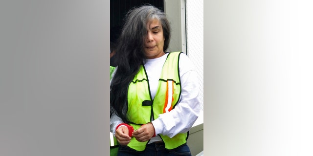 FILE - In this Aug. 20, 2013, file photo, provided by Mexico's Interior Department shows Sandra Avila Beltran in handcuffs as she is escorted by federal authorities upon arrival to Benito Juarez airport in Mexico City. A Mexican federal judge has thrown out a five-year, money-laundering sentence against Avila, ordering the immediate release of the so-called Queen of the Pacific for her alleged role as a liaison between Mexican and Colombian cartels. A statement issued Saturday Feb. 7, 2015, by the Attorney Generals Office says the judge ruled that Avila had already been tried for the same crime in Mexico and the United States. (AP Photo/Mexico Interior Department, File)