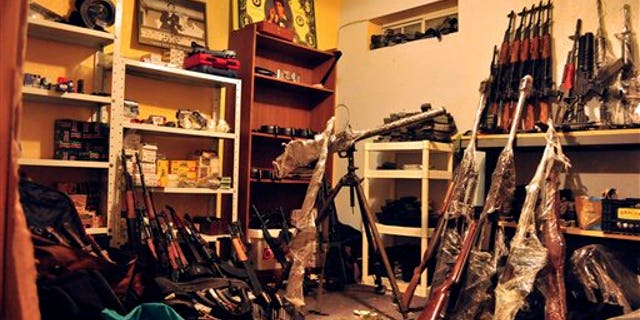 April 30: An arsenal containing grenades, grenade launchers, assault rifles and other high-powered weapons are stored inside a basement warehouse in the city of Ciudad Juarez, Mexico. Police say they found the stash in an underground room hidden behind the mirrors of a home exercise gym. The stockpile also includes police uniforms and bulletproof vests. The mirrors opened at the touch of a button near the floor. (AP)