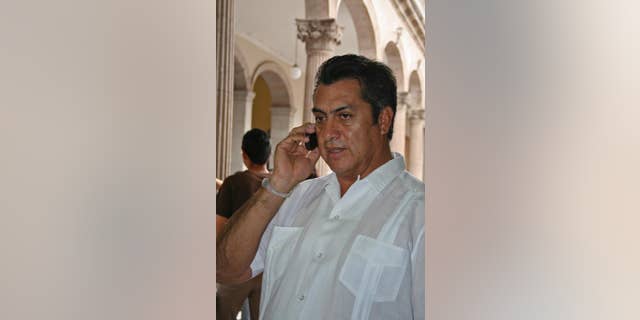 FILE - In this March 30, 2011 file photo, Jaime Rodriguez, mayor of the Mexican town Villa Garcia, speaks on a cellphone in Monterrey, Mexico, a day after he survived an assassination attempt. As mayor of a suburb of the northern industrial city of Monterrey, Rodriguez survived two assassination attempts that left his car bullet-ridden, defying, he says, the fierce Zetas cartel. Now he is trying to beat the odds in another way, running as an independent for governor of Nuevo Leon, a wealthy and strategic state bordering Texas. (AP Photo, File)
