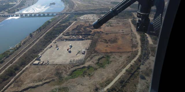 In this March 12, 2014, Mexican federal police fly over the Balsas River near the Pacific port of Lazaro Cardenas, Mexico.