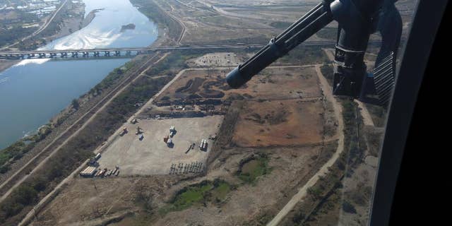 In this March 12, 2014, Mexican federal police fly over the Balsas River near the Pacific port of Lazaro Cardenas, Mexico.